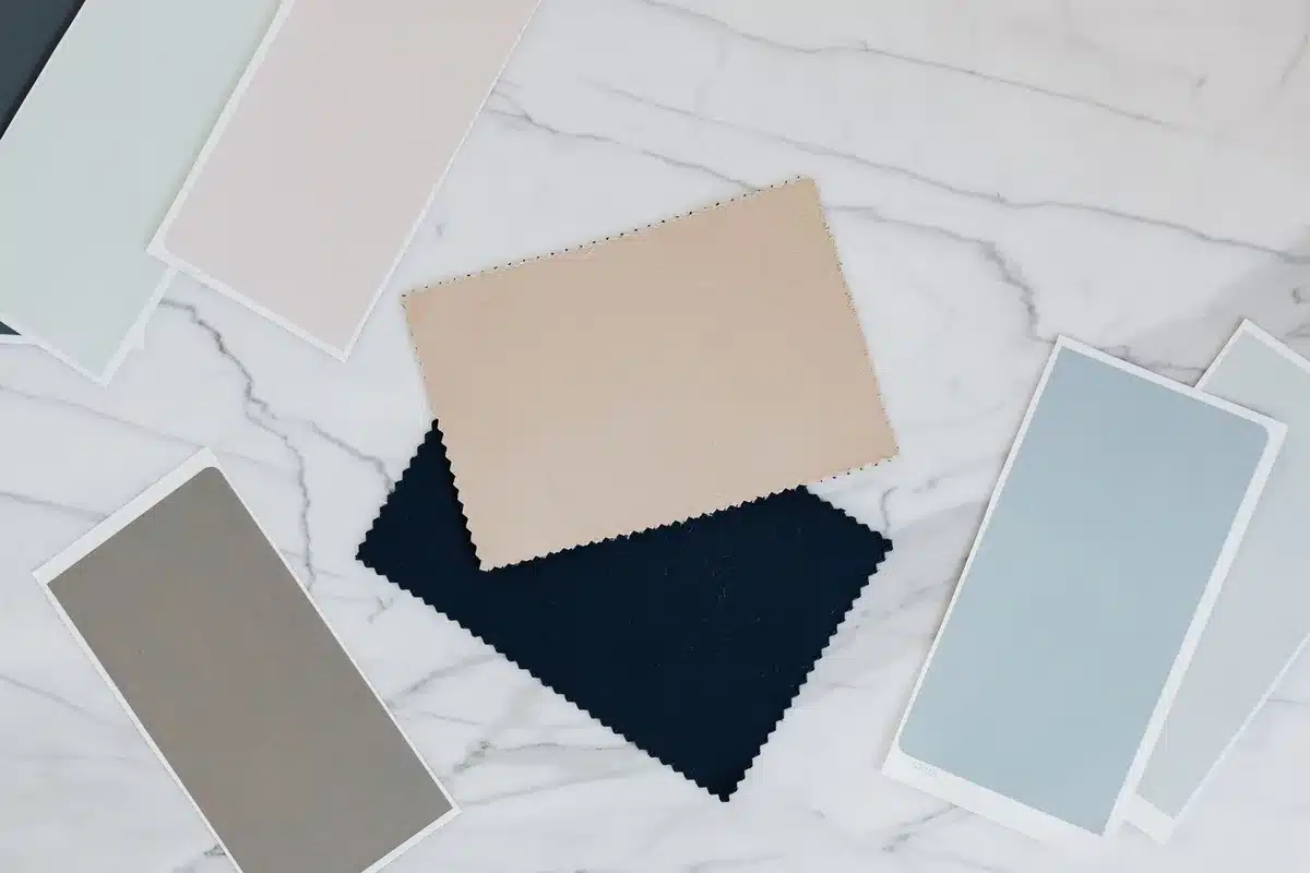 Muestras de telas en tonos beige, blanco, azul marino y rojo mostrando los colores de temporada