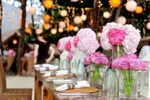 Manos sosteniendo estatuillas genéricas en una mesa durante una celebración de premios